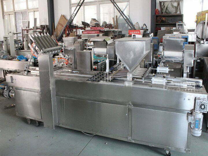 Commercial cake depositor with cup filling function